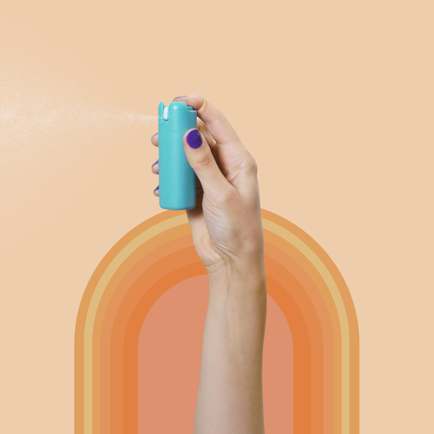 A hand holds a Sanikind sanitizer dispenser against an orange background.