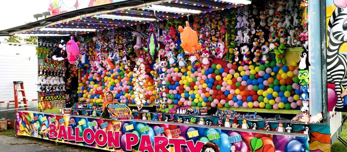 games-of-chance-with-balloons-at-county-fair-in-a-2022-11-12-10-43-02-utc